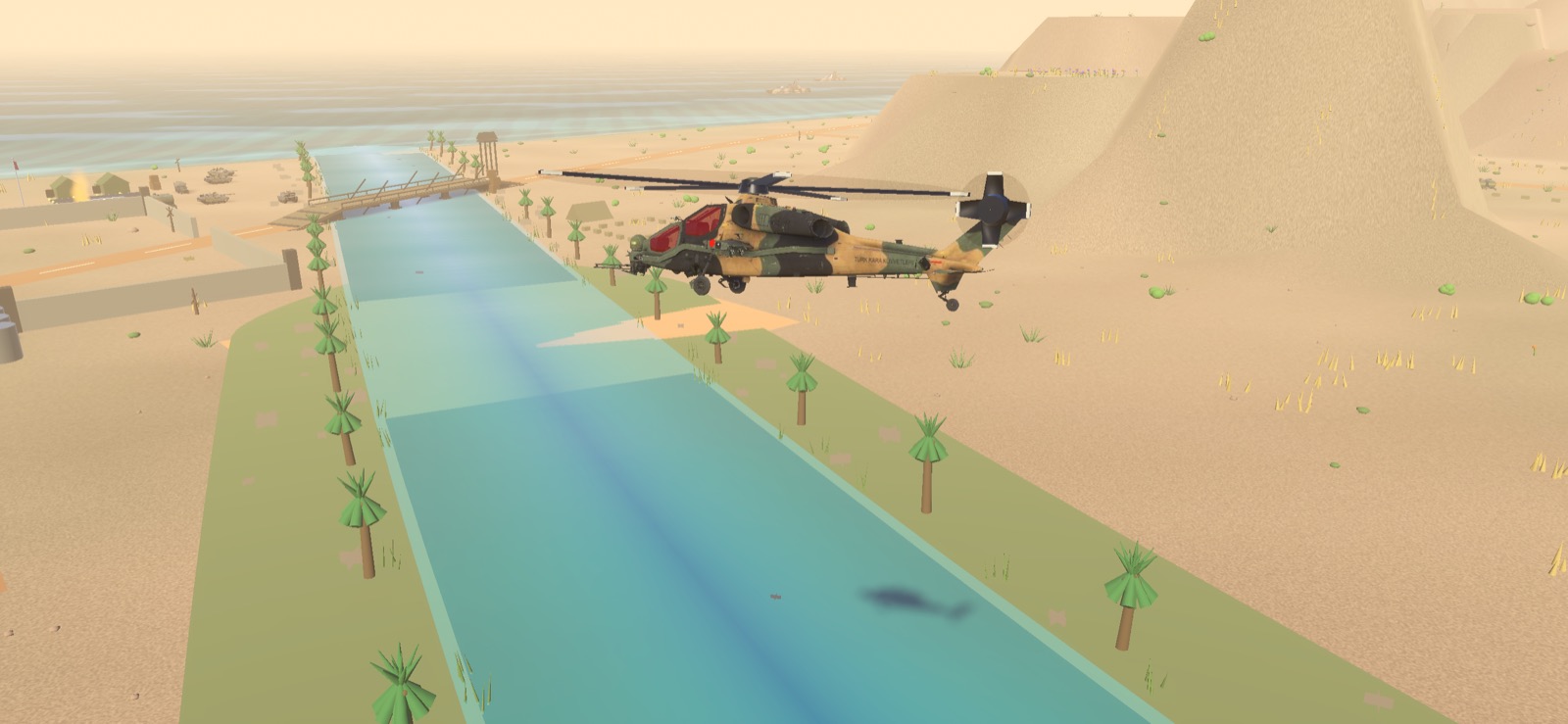 A T-129 ATAK following a green river valley toward the coast